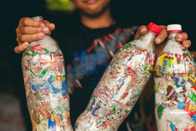 Recycling plastic bottles filled with various plastic waste for environmental sustainability.