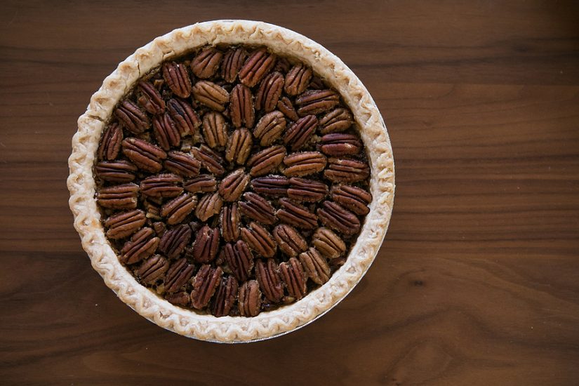 Pecan pie with toasted pecans in a classic crust, perfect for traditional dessert lovers.