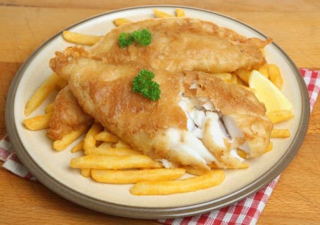 Delicious homemade fish and chips served with crispy fries and fresh lemon wedges. Perfect comfort f.