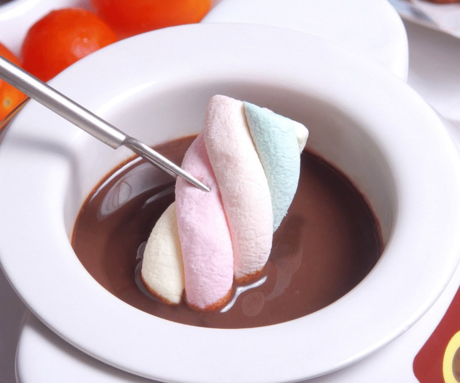 Delicious chocolate fondue served with colourful marshmallows, perfect for sharing and dessert.