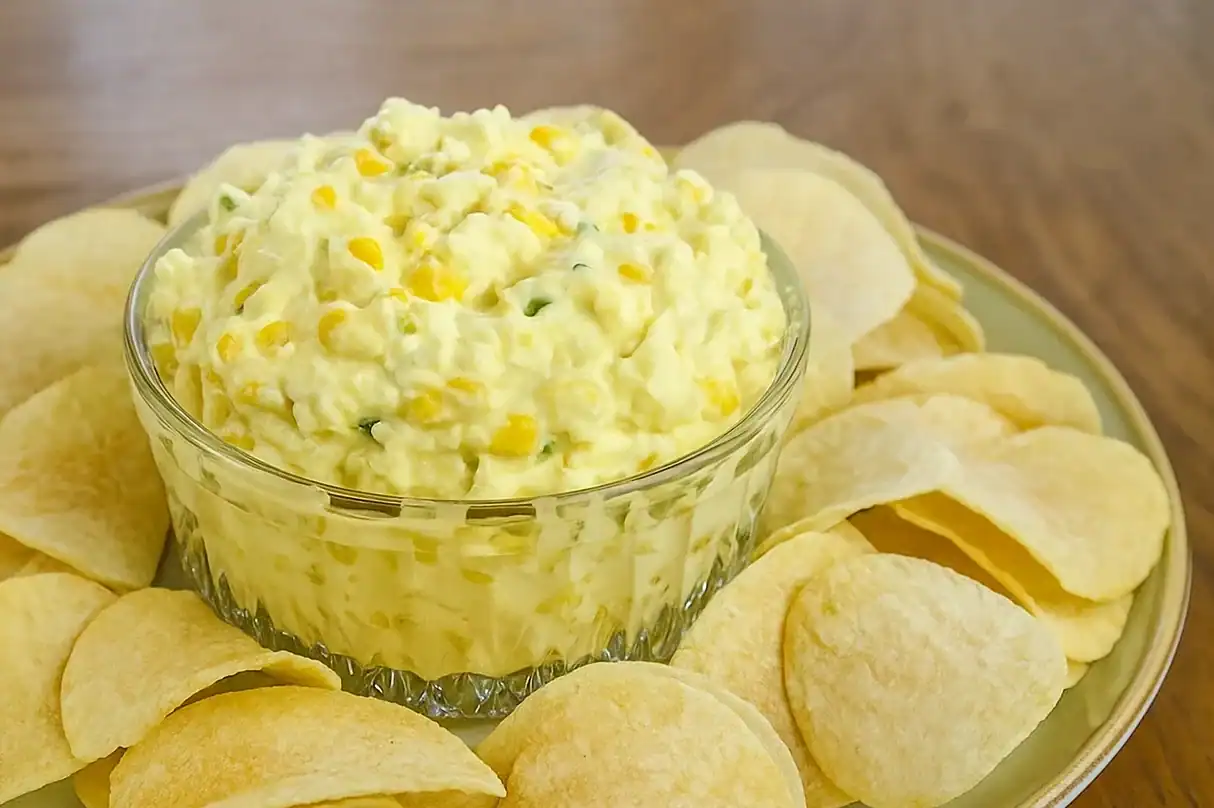 Delicious corn relish dip served with crispy potato chips, perfect for snacks or parties.