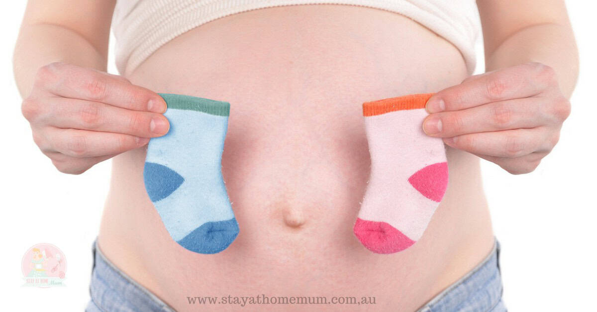 Pregnancy gender prediction using old wives' trick with baby socks.