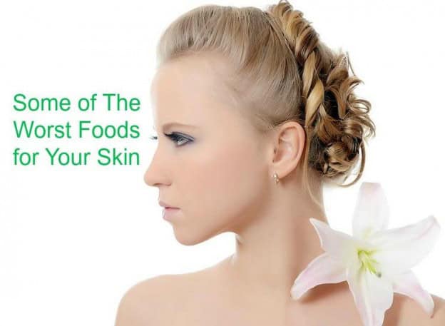 Woman with clear skin and a lily flower, highlighting skin health concerns.