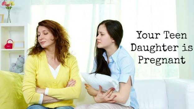 Teen daughter and mother having serious talk about pregnancy at home.