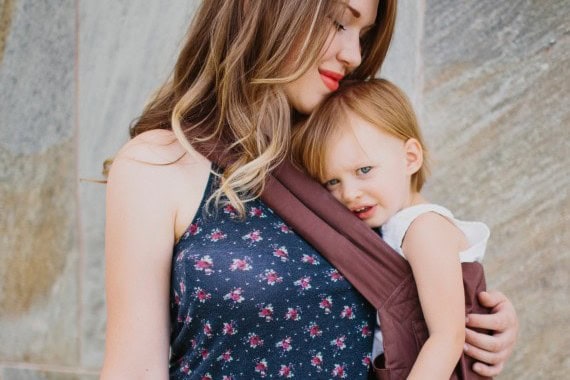 Mother and toddler using a baby carrier for comfortable baby wearing.