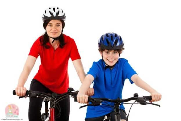 Mum and son riding bikes together, promoting family outdoor activity.