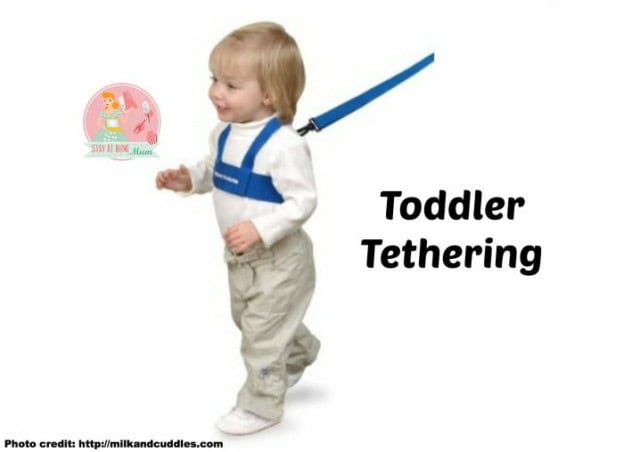 Child wearing a toddler tether for safety during outdoor activities.