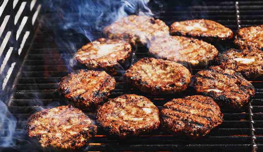 Grilled Moroccan-style home hamburgers with aromatic spices on a barbecue grill.