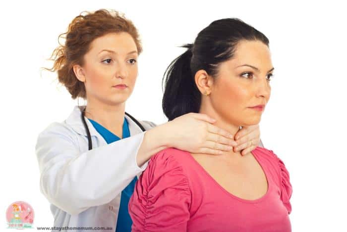 Doctor examining woman's neck for thyroid issues.