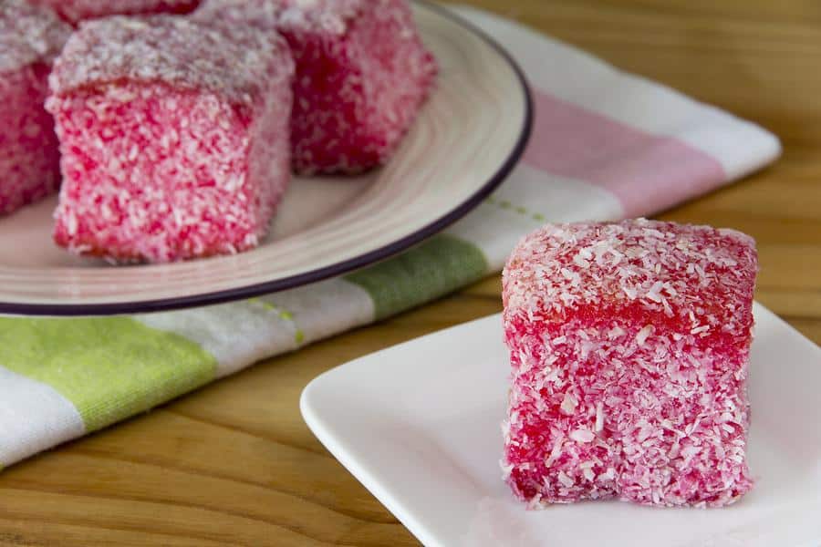 Delicious pink jelly cakes with coconut coating, perfect for nostalgic treats and family gatherings.