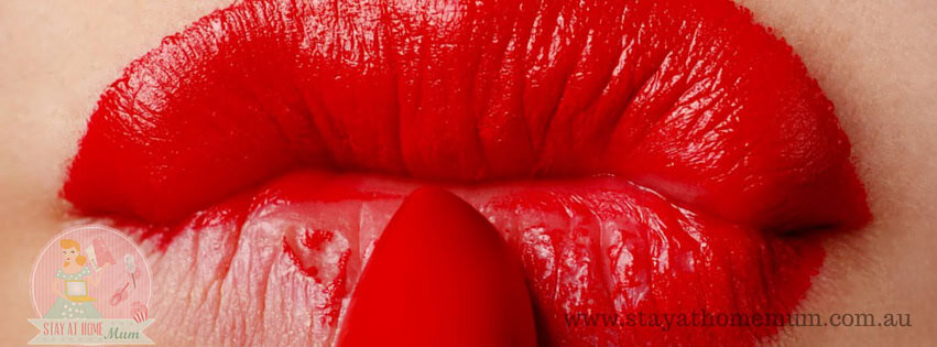 Close-up of vibrant red lipstick on lips, perfect for a glamorous look.