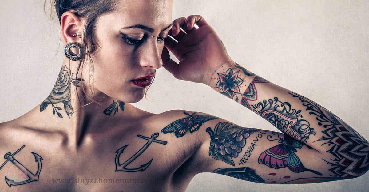 Woman with tattoos considering tattoo removal treatment.