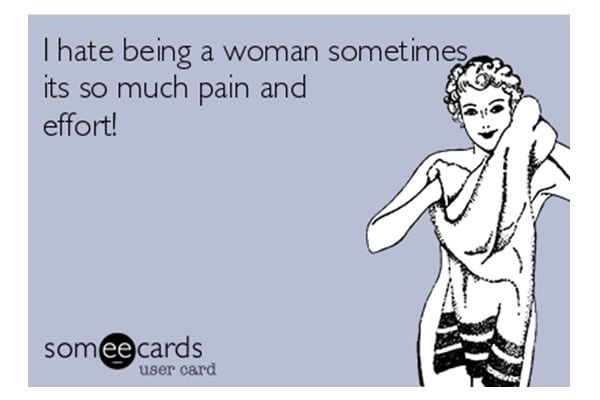 Woman holding laundry with a frustrated expression, illustrating challenges faced by women.