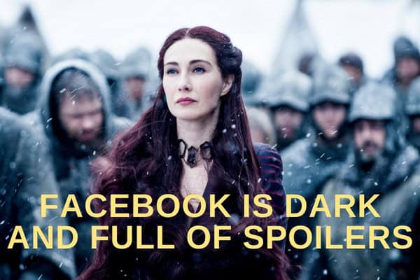 Woman with dark hair and serious expression, surrounded by people in a snowy setting.