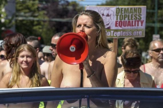 Woman speaking into a megaphone during a protest for topless equality.