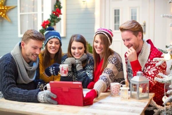 Happy family enjoying Christmas activities at home with minimal expenses.