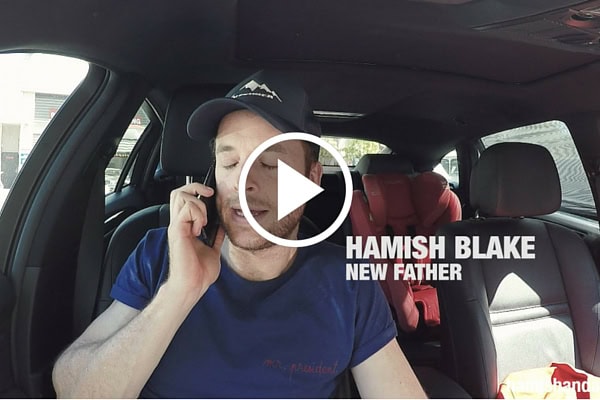 Father talking on phone about parent fantasies in a car.