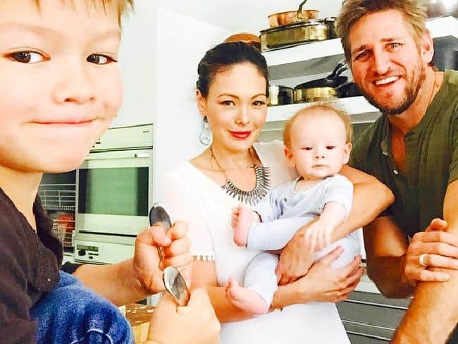 Family cooking with kids in a contemporary kitchen setting.