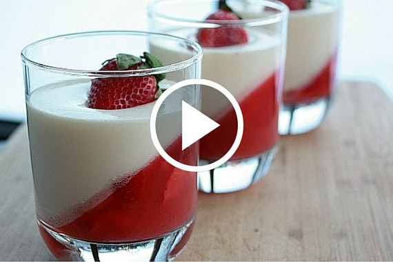 Strawberry panna cotta served in glasses with fresh strawberries and mint, perfect for a sweet treat.