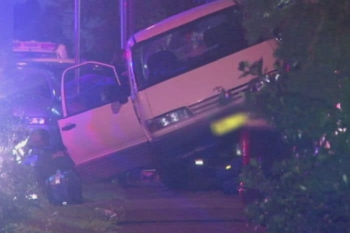 Bus accident scene at night with vehicle off the road.