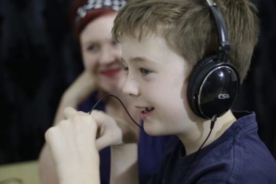 Child wearing headphones during a child development assessment for learning delays.