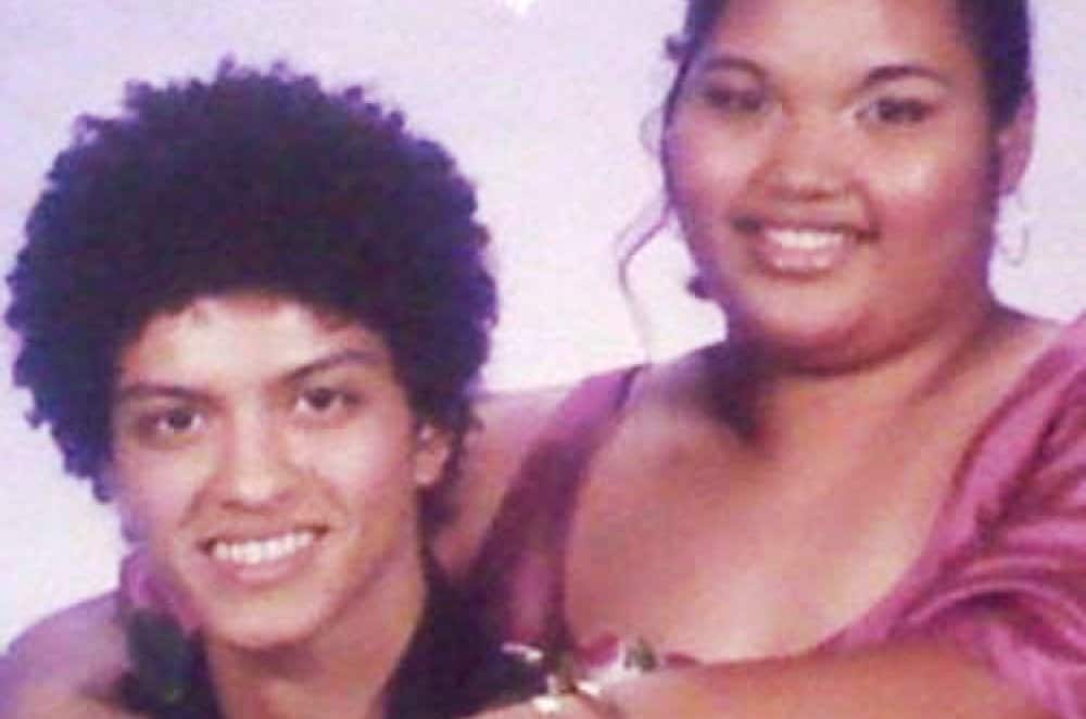 Prom night with a joyful mother and son sharing a special moment.
