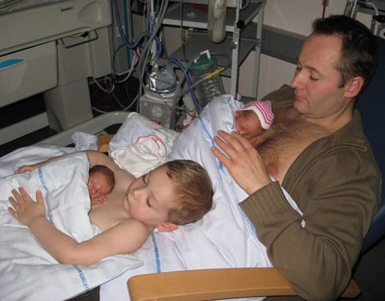 Incredible Photo of Young Boy Helping Dad Make Skin-to-Skin Contact with Siblings Goes Viral
