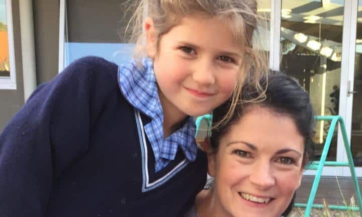 Happy mother and daughter celebrating school approval for wearing shorts.