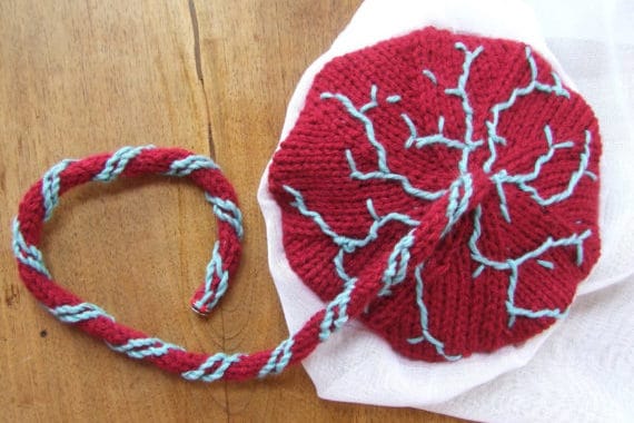 Unique knitted placenta representation with red and blue yarn.