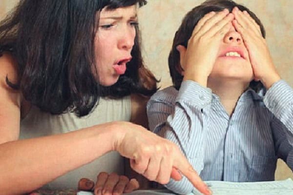 Overbearing mother criticizing her child, highlighting helicopter parenting issues.