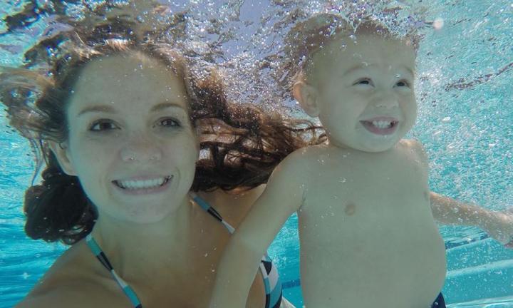 Swimming with a one-year-old boy learning to swim unassisted.