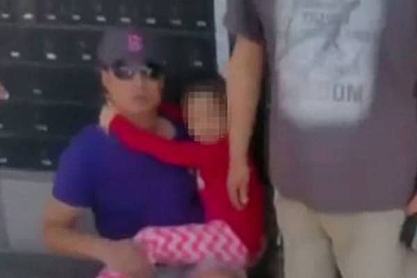 Child girl with sunglasses and red top after being crushed between cars.