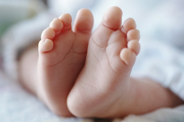 Close-up of a baby's tiny feet, symbolising hope and new life.