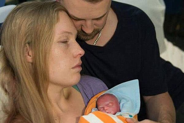 Heartfelt moment of a mother holding her stillborn baby.