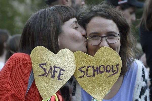 Protesters hold heart-shaped signs reading "Safe Schools" at a rally in Sydney's northwest.