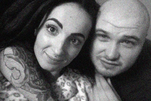 Mother and partner smiling together in a close-up photo.