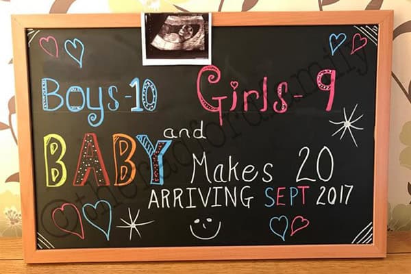 Chalkboard announcement of a large family expecting their 20th baby in 2017.