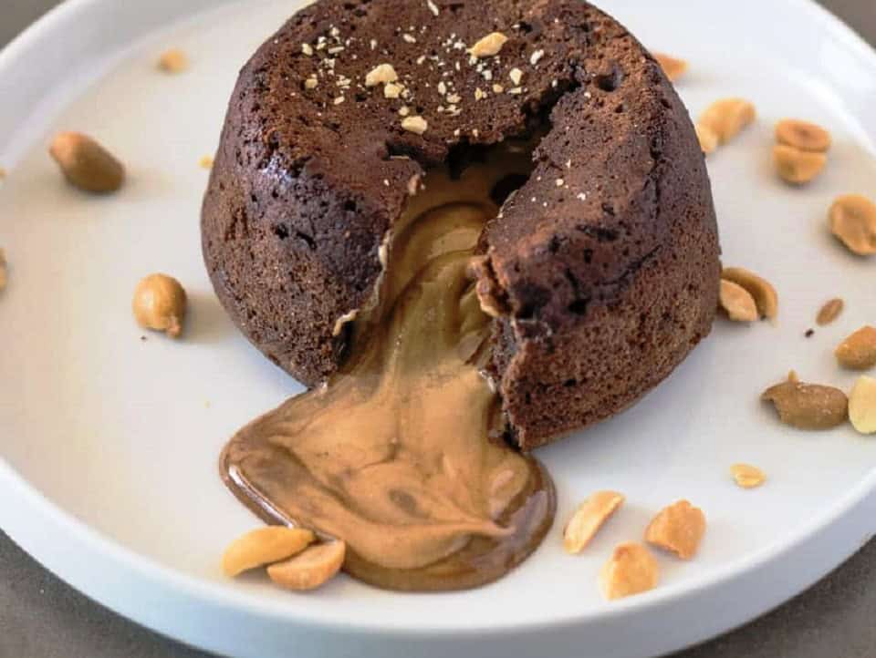 Rich gooey chocolate lava cake with melting center and crunchy peanut topping.
