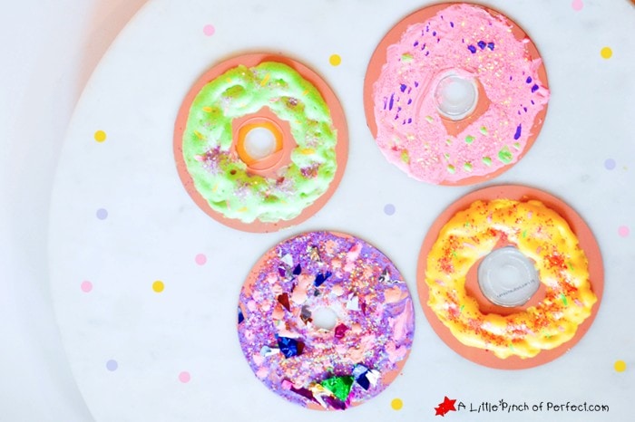 Brightly decorated puff paint donuts for craft activities.