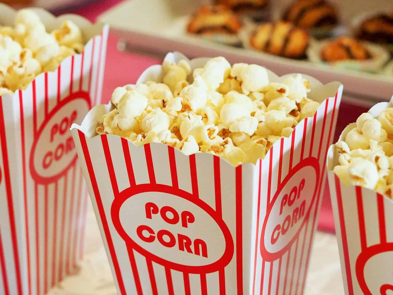 Popcorn in a striped red and white box, perfect for movie snacks.