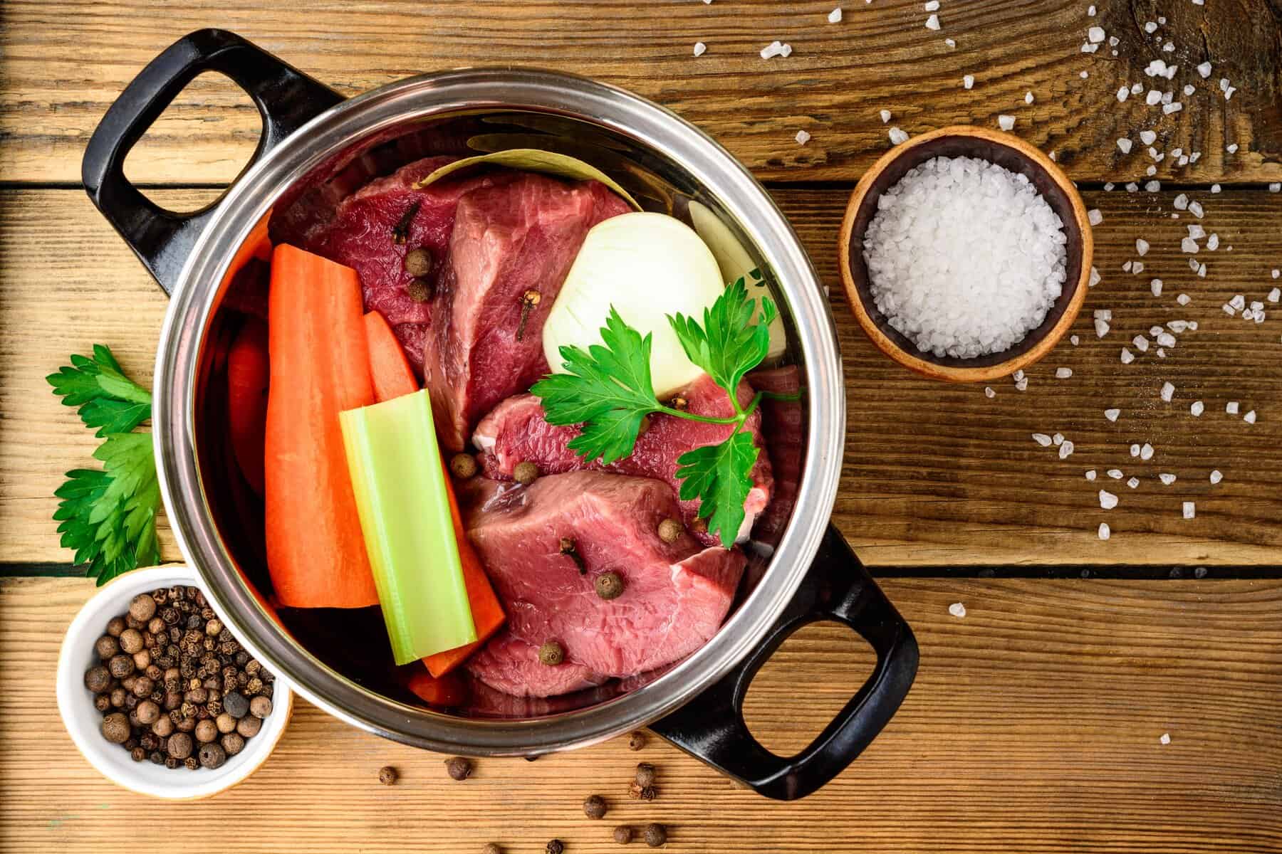 Healthy beef bone broth with vegetables and herbs.
