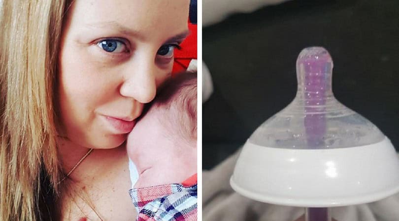 Mother with her baby, preparing to give medicine using a baby bottle.