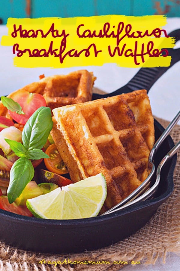 Hearty cauliflower breakfast waffles with fresh vegetables and lemon wedges. Perfect for a healthy,.