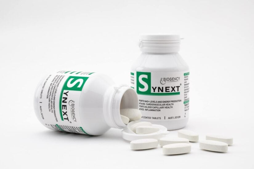 BioGenic YNEXT supplement bottle with tablets on white background.