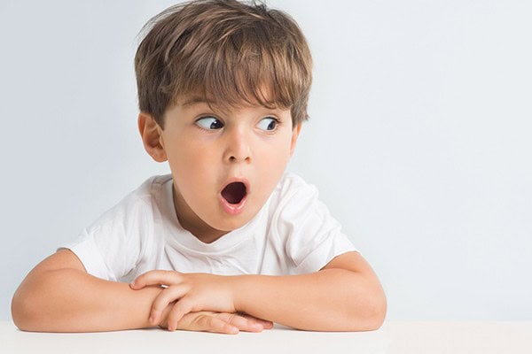 Child with surprised expression saying the darndest things.