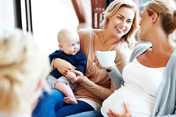 Happy SAHMs meeting friends with their children.