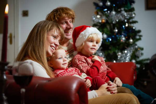 Family enjoying Christmas movies together during the holiday season.