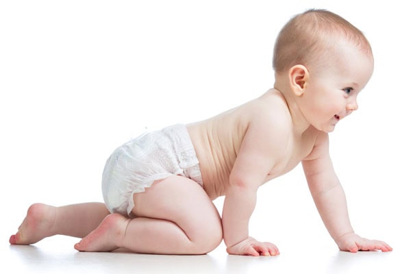 Baby crawling on the floor, exploring dirt and environment.