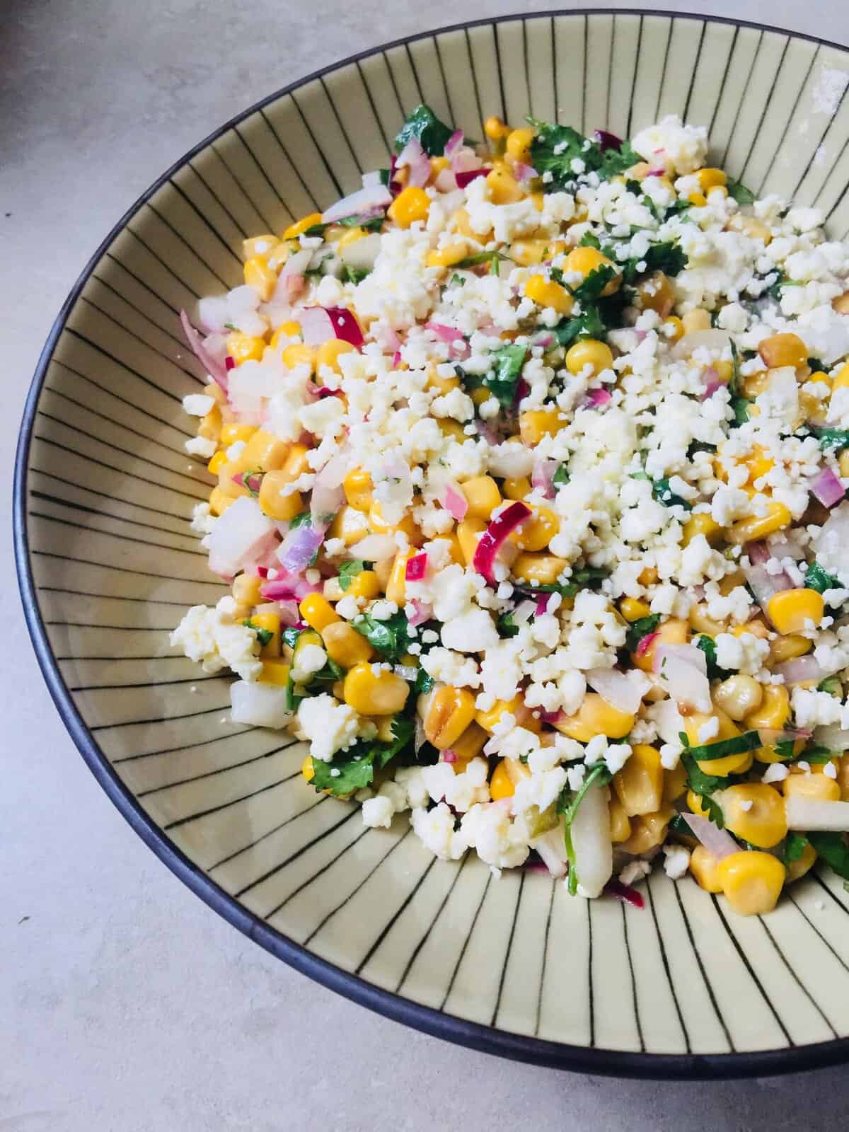 Delicious Mexican street corn salad with fresh corn, cheese, and herbs. Perfect for summer gathering.