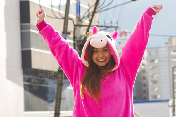 Bright pink unicorn onesie with a playful hood and horn.